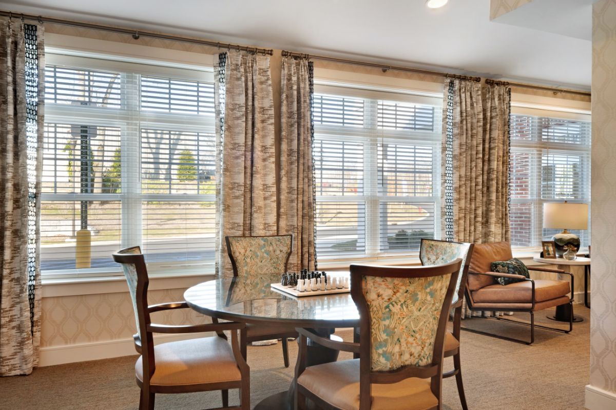 A cozy dining area with elegant chairs and a large window view.