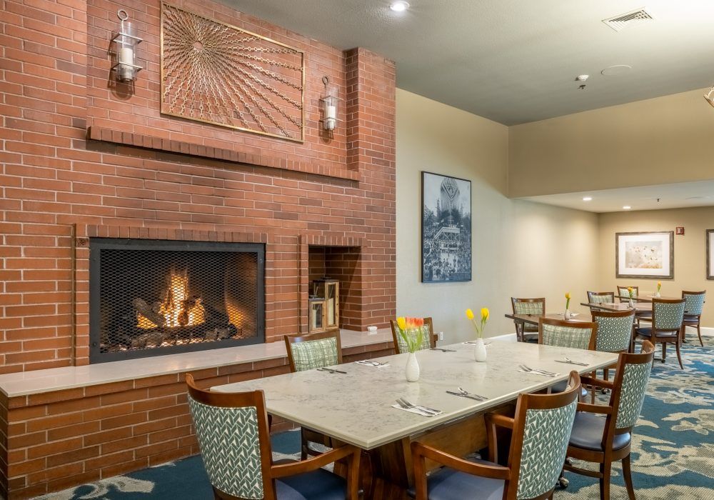 A cozy dining room with a fireplace and elegant seating arrangement.