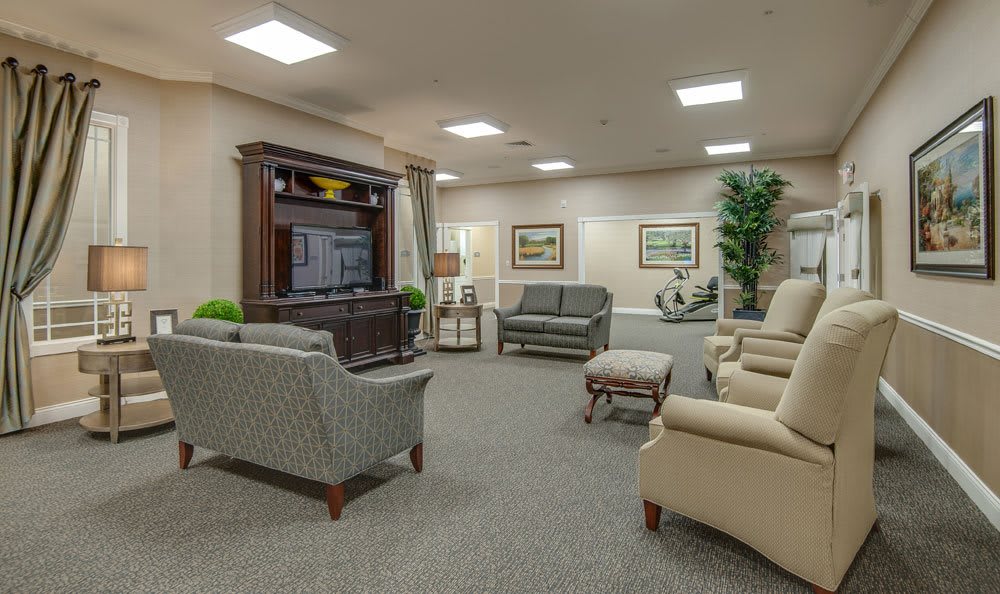 A spacious living room with comfortable seating, a large television, and tasteful decor.