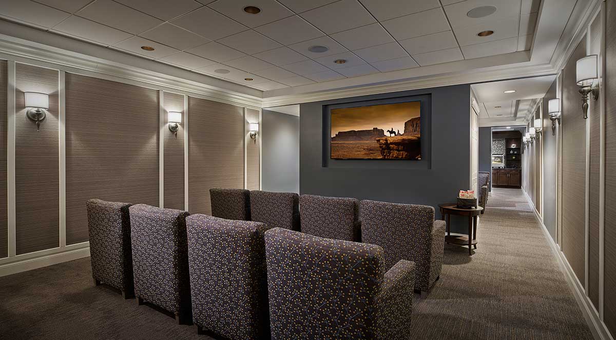 A modern home theater setup with comfortable seating and a large screen for entertainment.