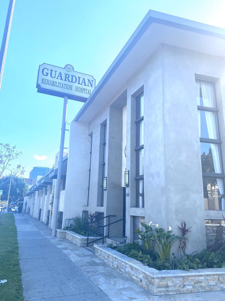 A street view of a building with a sign for Guardian Children's School.