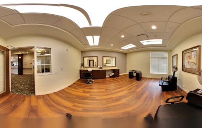 A modern office space with wooden flooring and contemporary furnishings.