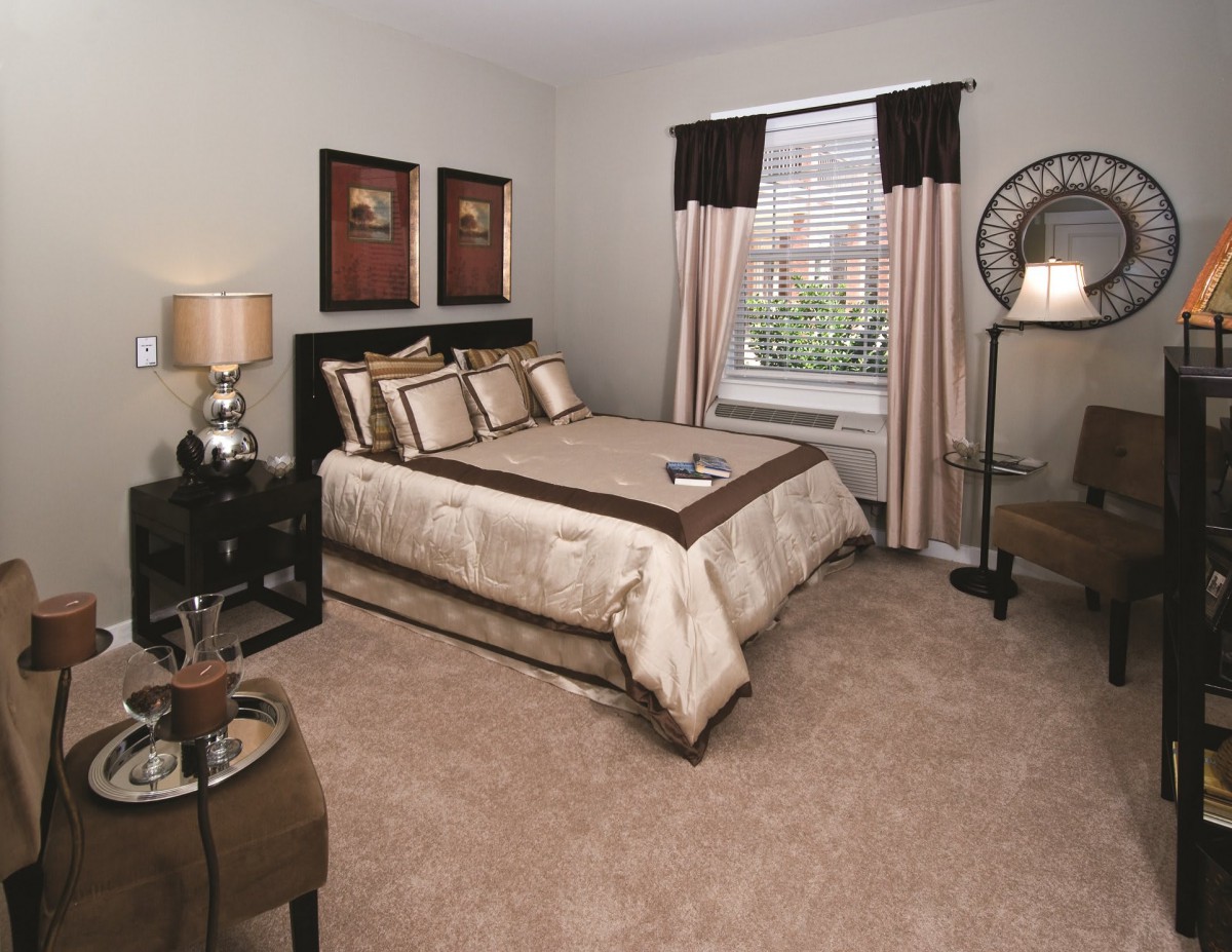 A cozy bedroom with elegant decor and a neatly made bed.
