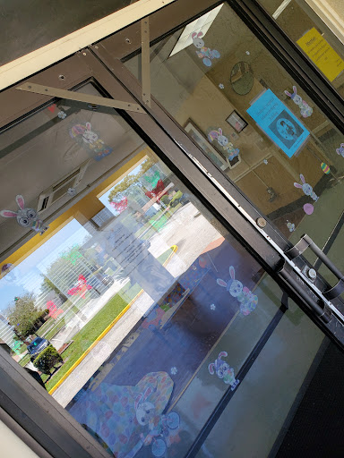 A view of a storefront entrance with glass doors and visible signage.