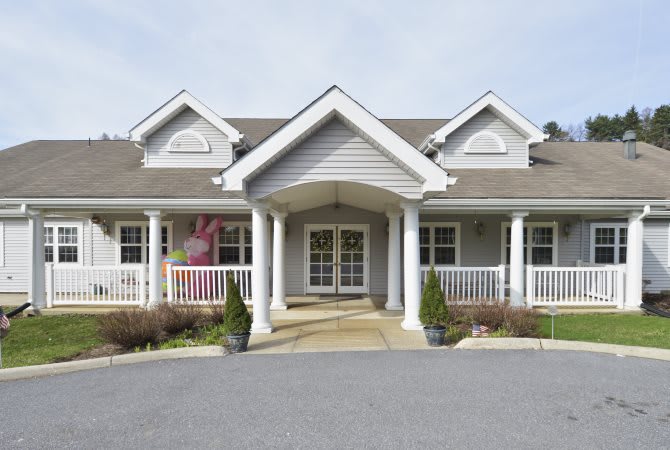 A suburban house with a front porch and columns.