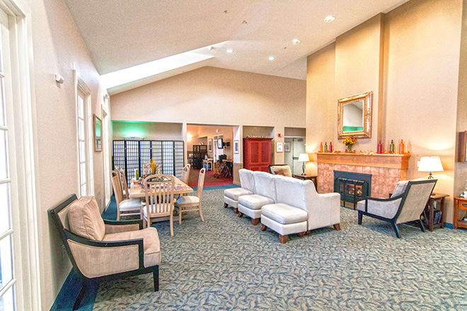 A spacious and elegantly designed hotel lobby with comfortable seating and a fireplace.