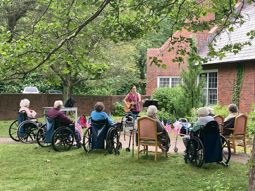 Residents enjoying a live music performance in the garden.