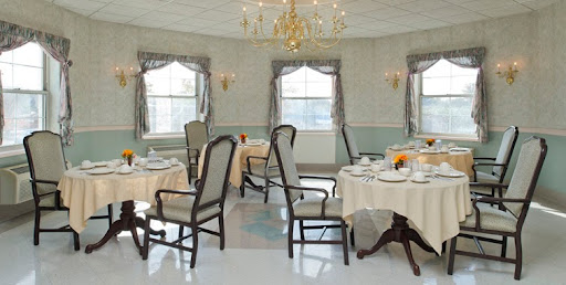 A beautifully arranged dining room featuring elegant furniture and soft natural lighting.