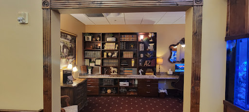 A well-organized office space featuring a bookshelf filled with various books and decorative items.
