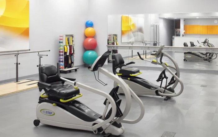 A therapy gym with specialized workout machines and colorful exercise balls.