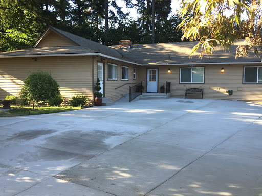 A cozy residential home with a spacious driveway and well-maintained front yard.