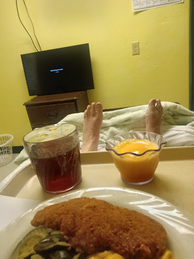 A cozy hospital room with a meal and some entertainment.