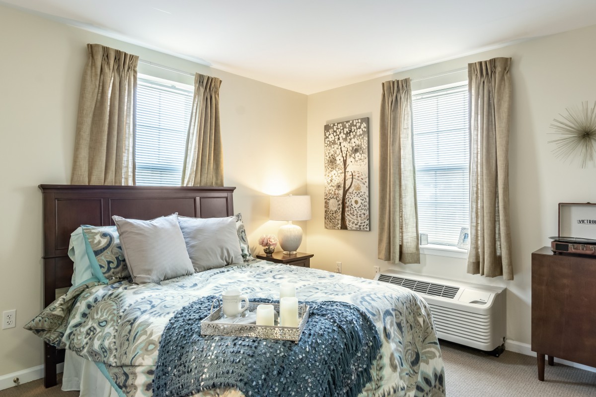Cozy bedroom with elegant decor and natural light.