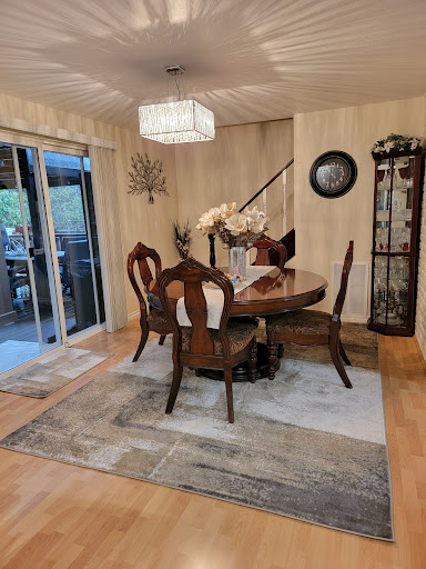 A cozy and elegantly designed dining room featuring a wooden table, comfortable chairs, and tasteful decor.