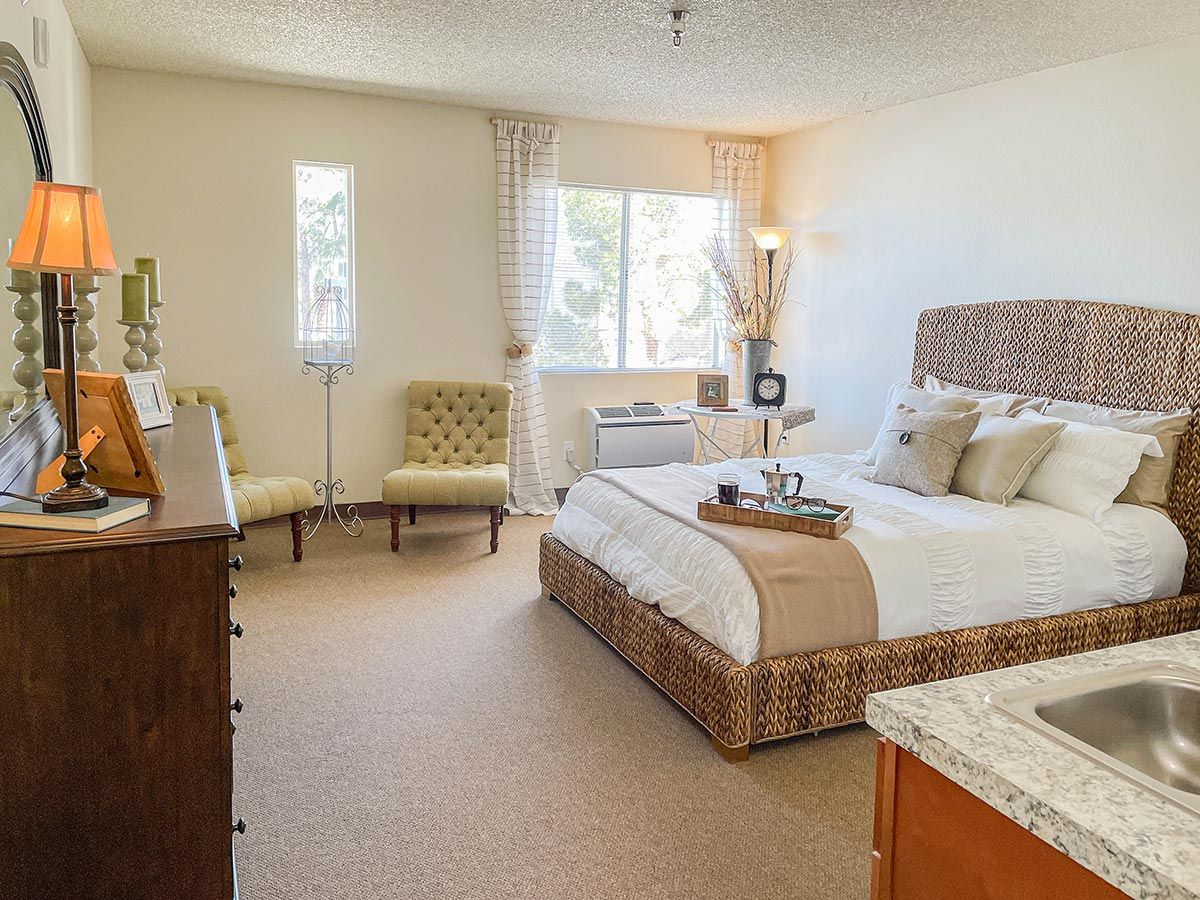 A cozy bedroom with stylish decor and natural light.