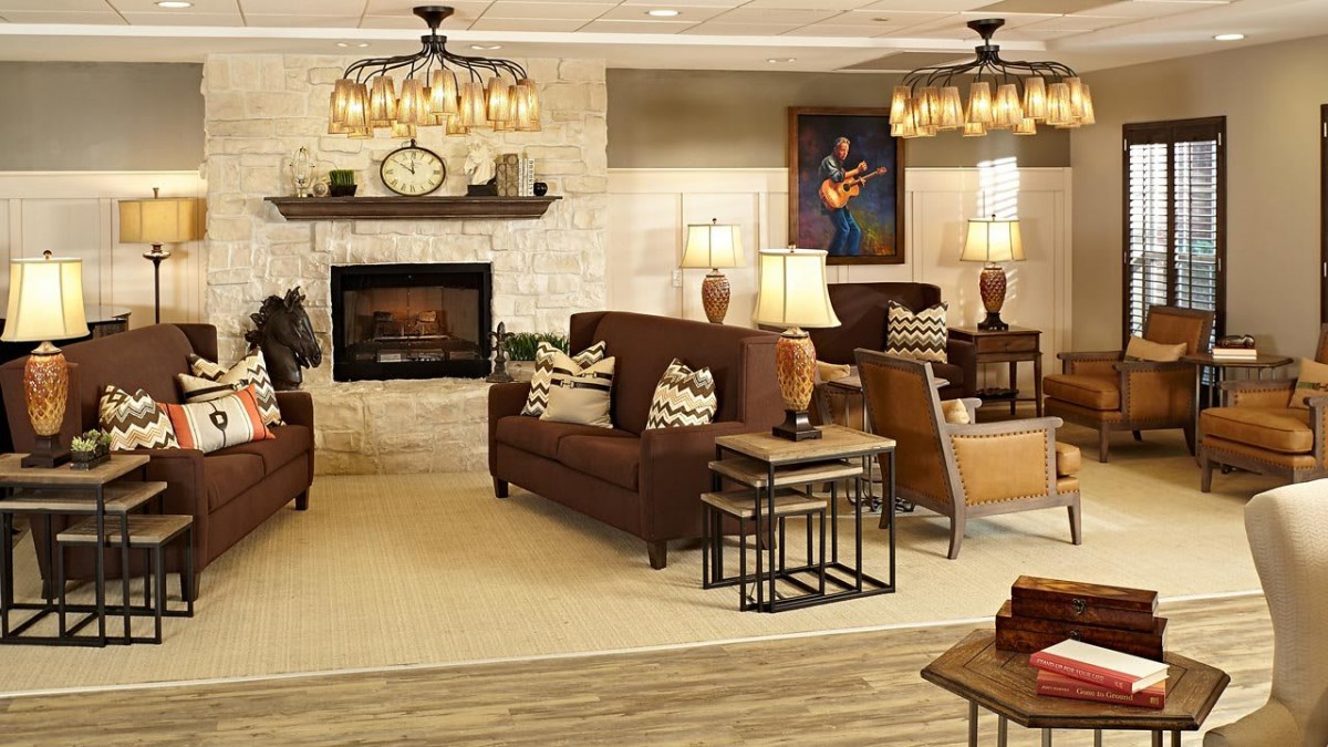 A cozy living room with a fireplace, comfortable seating, and elegant lighting.