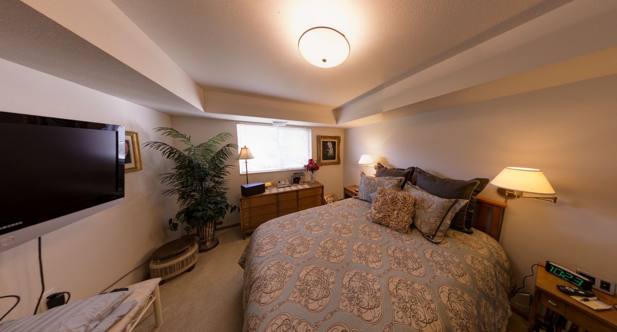 Cozy bedroom with elegant decor and soft lighting.