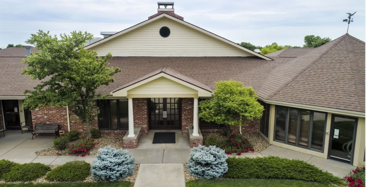 A well-maintained residential house with landscaped front yard and entrance.