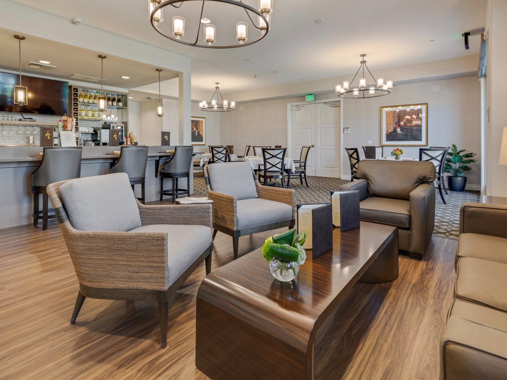 A modern lounge area with comfortable seating and a well-lit bar.