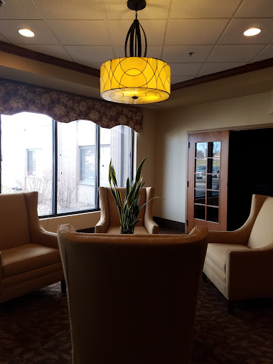 A cozy lounge area featuring modern furniture and warm lighting.