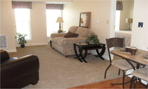 A cozy living room featuring a comfortable sofa, a side table, and warm lighting.