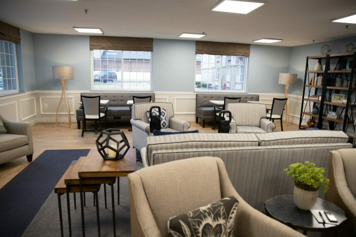 A cozy lounge area with comfortable seating and ample natural light.