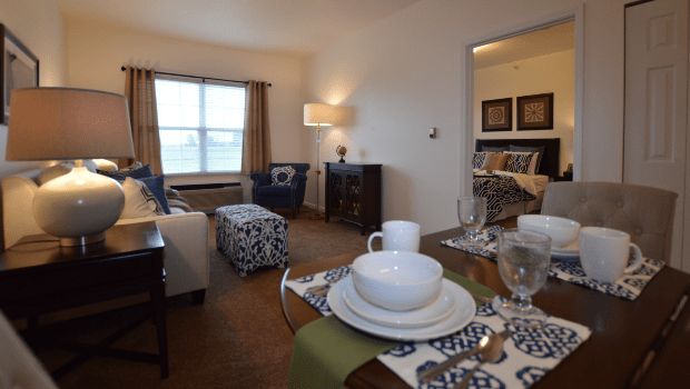 A cozy living room with a dining area, featuring comfortable furniture and stylish decor.