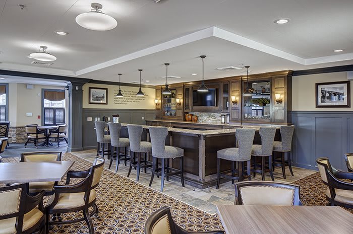 A modern bar area with stylish seating and elegant lighting.