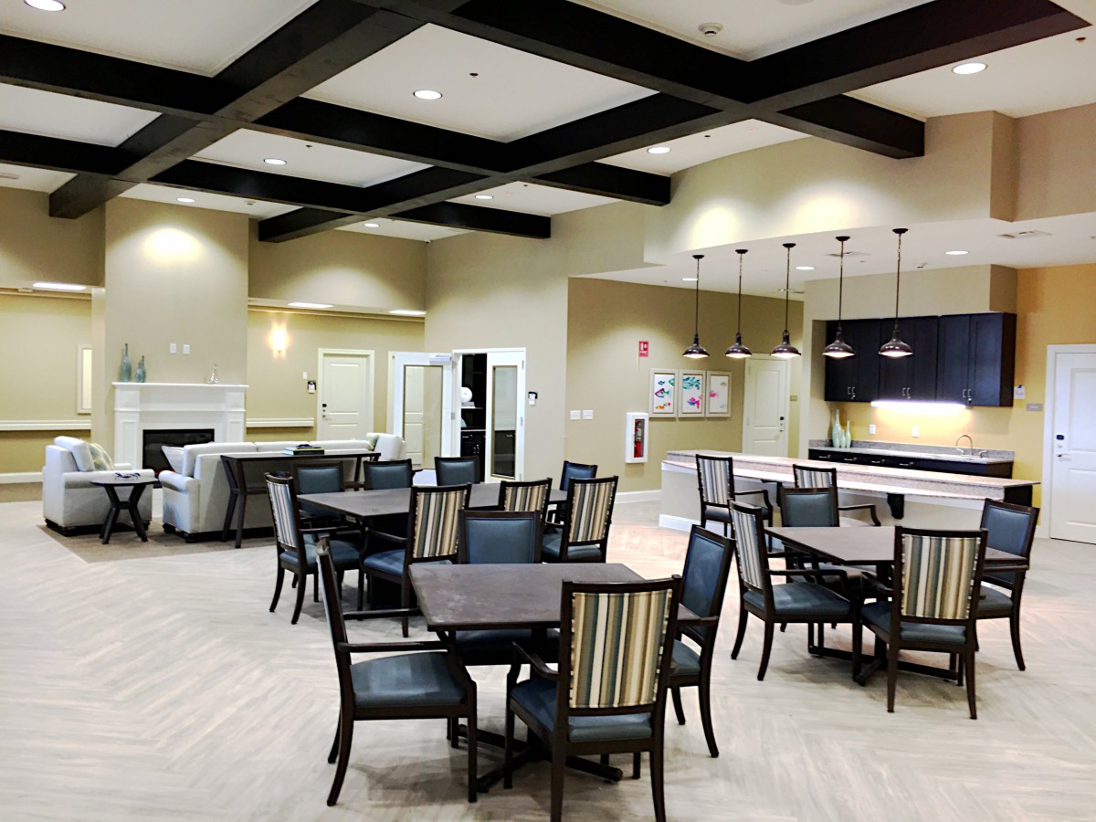 Modern dining area with multiple tables and chairs in an open, well-lit space.