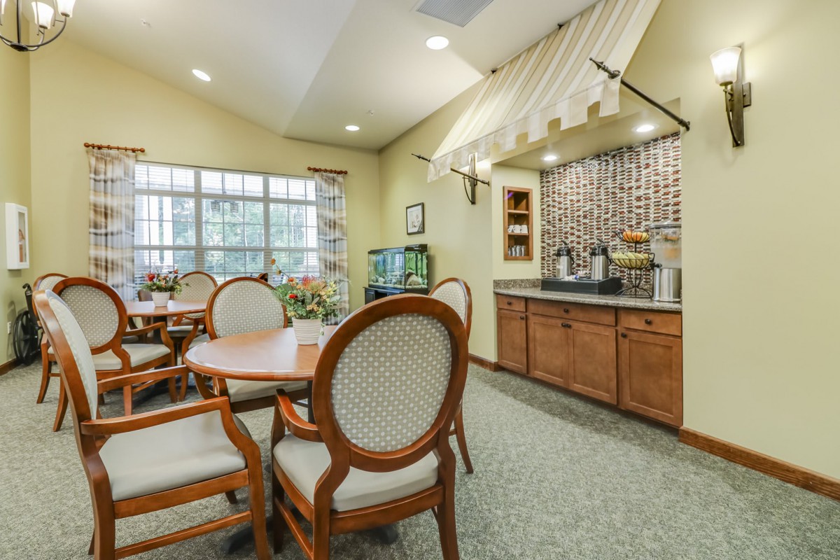 A cozy dining area with a kitchenette and elegant furniture.