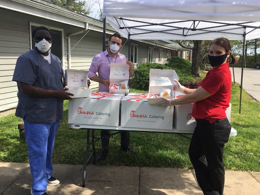 Volunteers come together to distribute food boxes to those in need during a community support event.