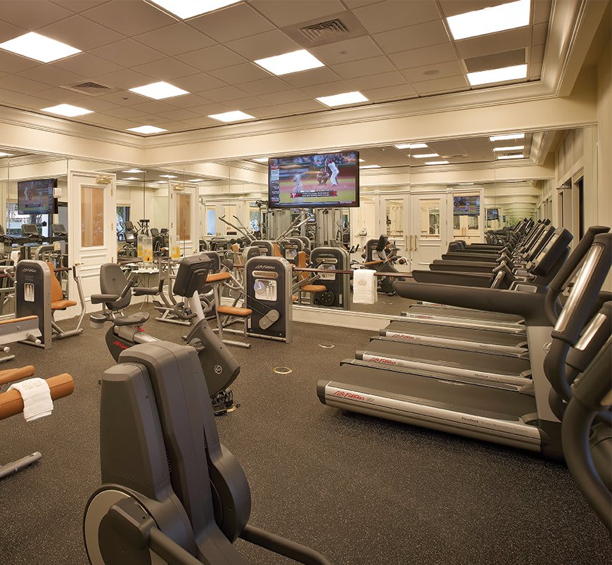 A well-equipped gym with treadmills and various workout machines.