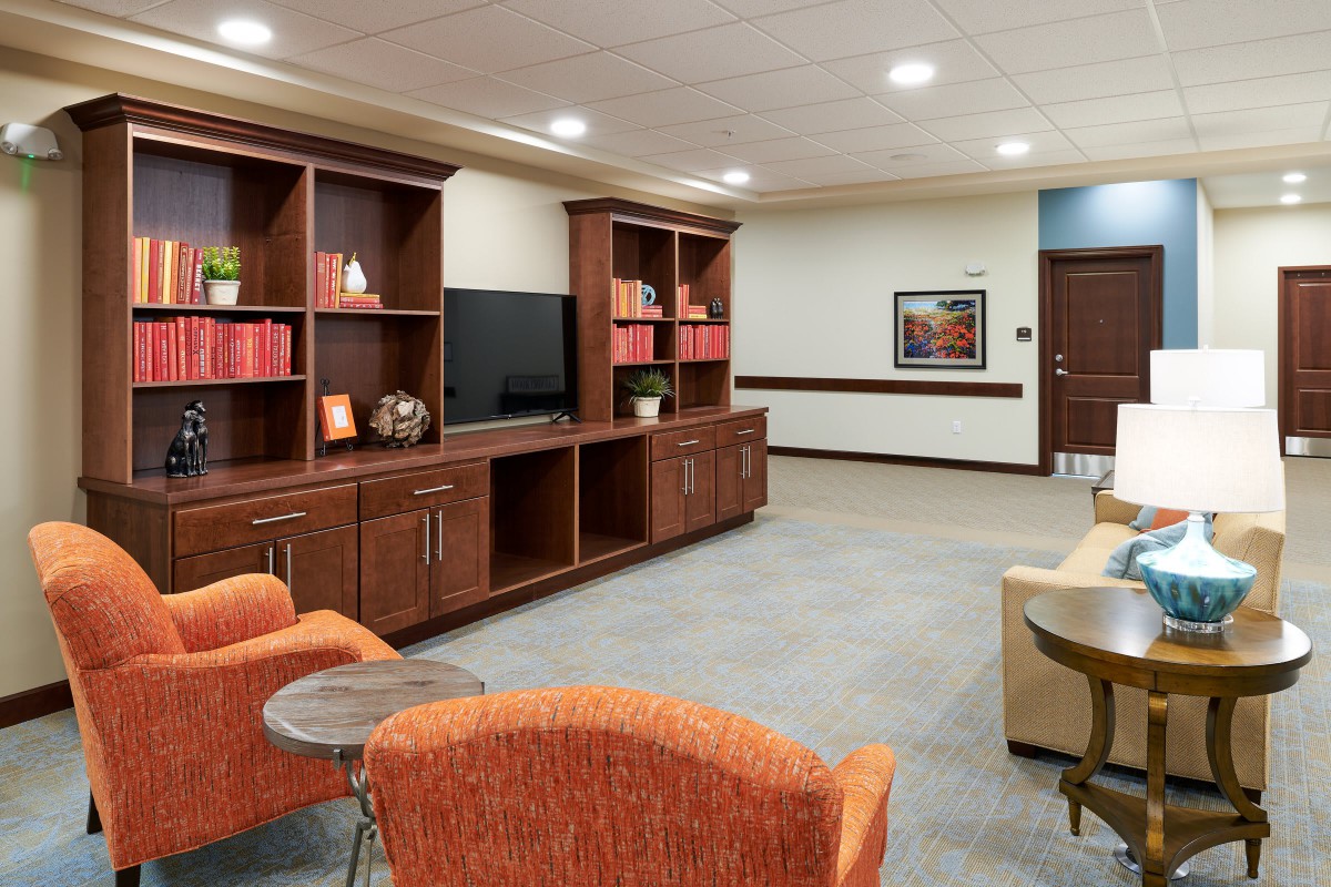 A modern living room with comfortable seating and a large television.