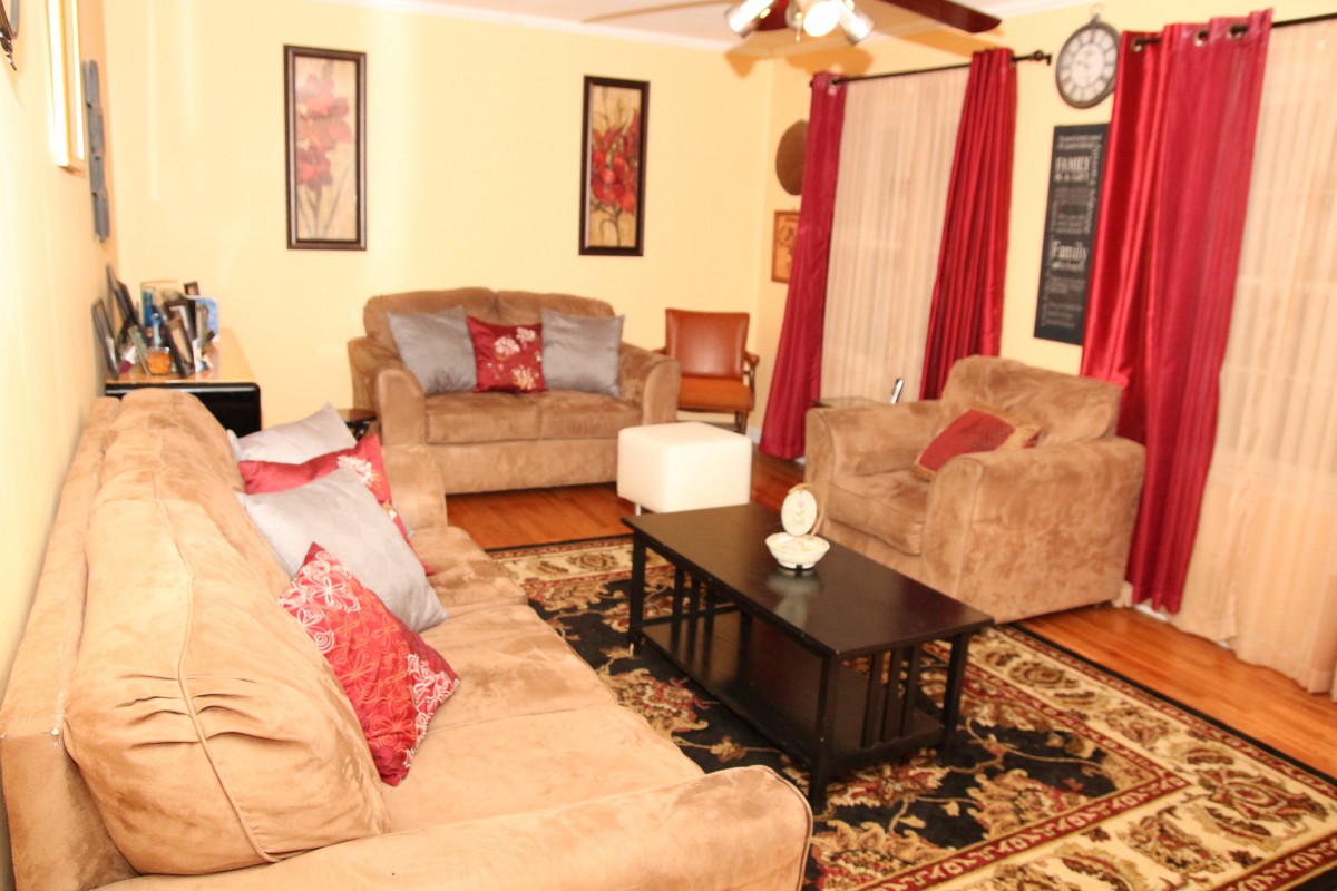 A cozy living room with comfortable sofas, a central coffee table, and warm decor.
