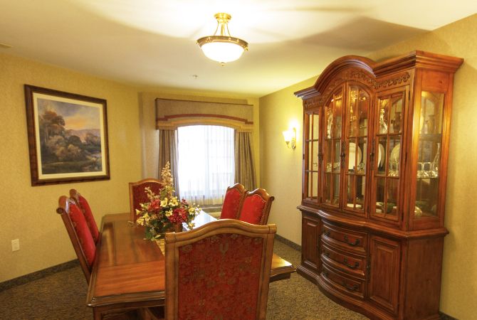 Elegant dining room with wooden furniture and a chandelier.