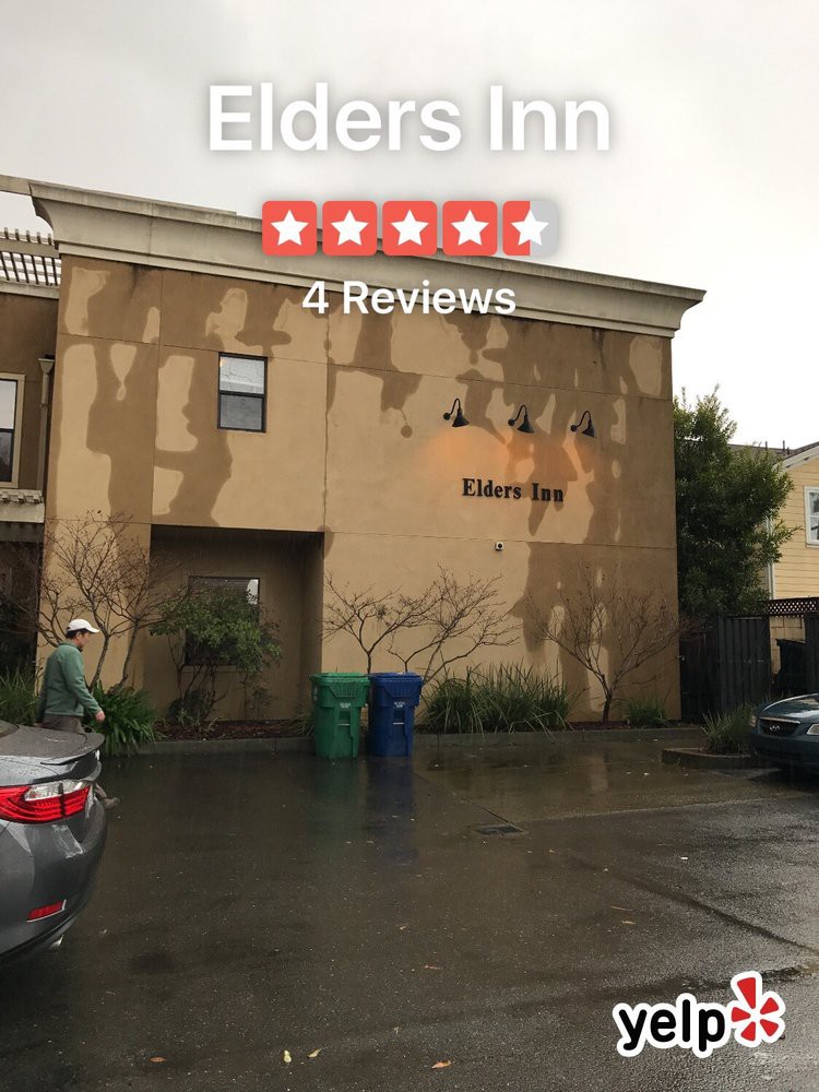 A hotel building with worn exterior and a visible 4-star rating from reviews.