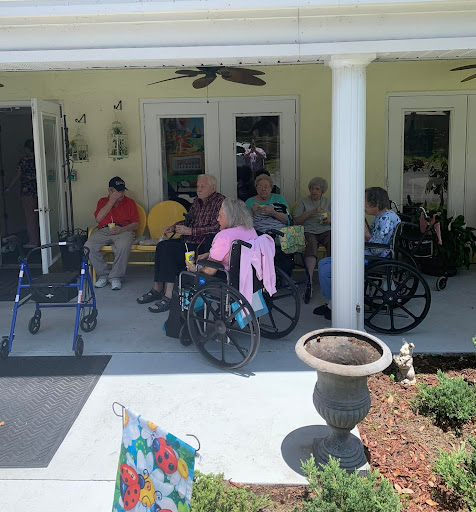 Residents enjoying a sunny day on the porch.