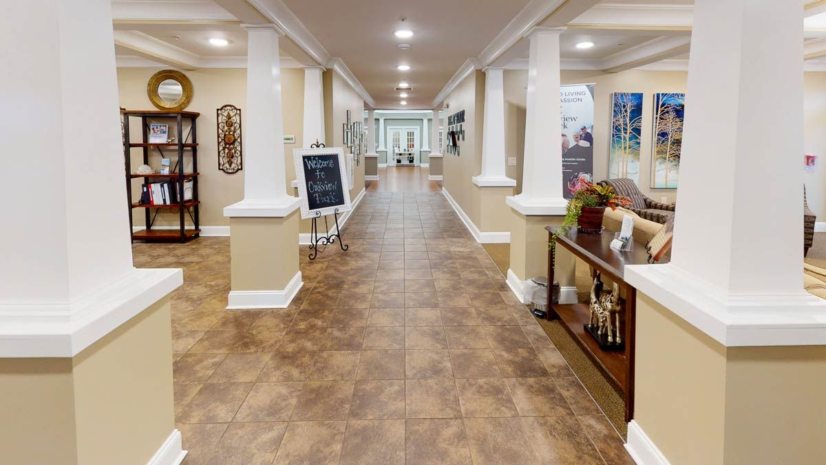 A well-lit hallway with decorative elements and furniture on both sides.