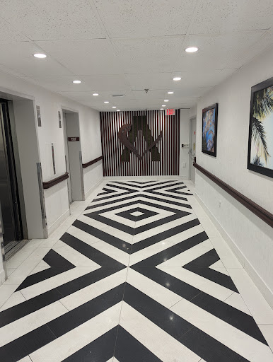 A stylish hallway showcasing modern design with a striking black and white geometric floor pattern.