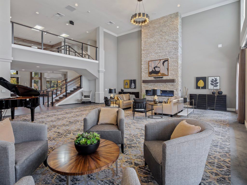 A modern living room with stylish furniture and a cozy fireplace.