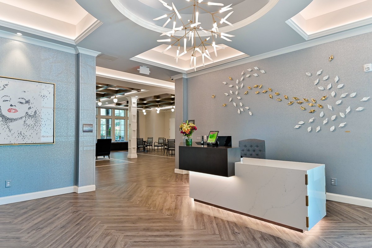A modern reception area featuring elegant chandeliers and stylish decor.