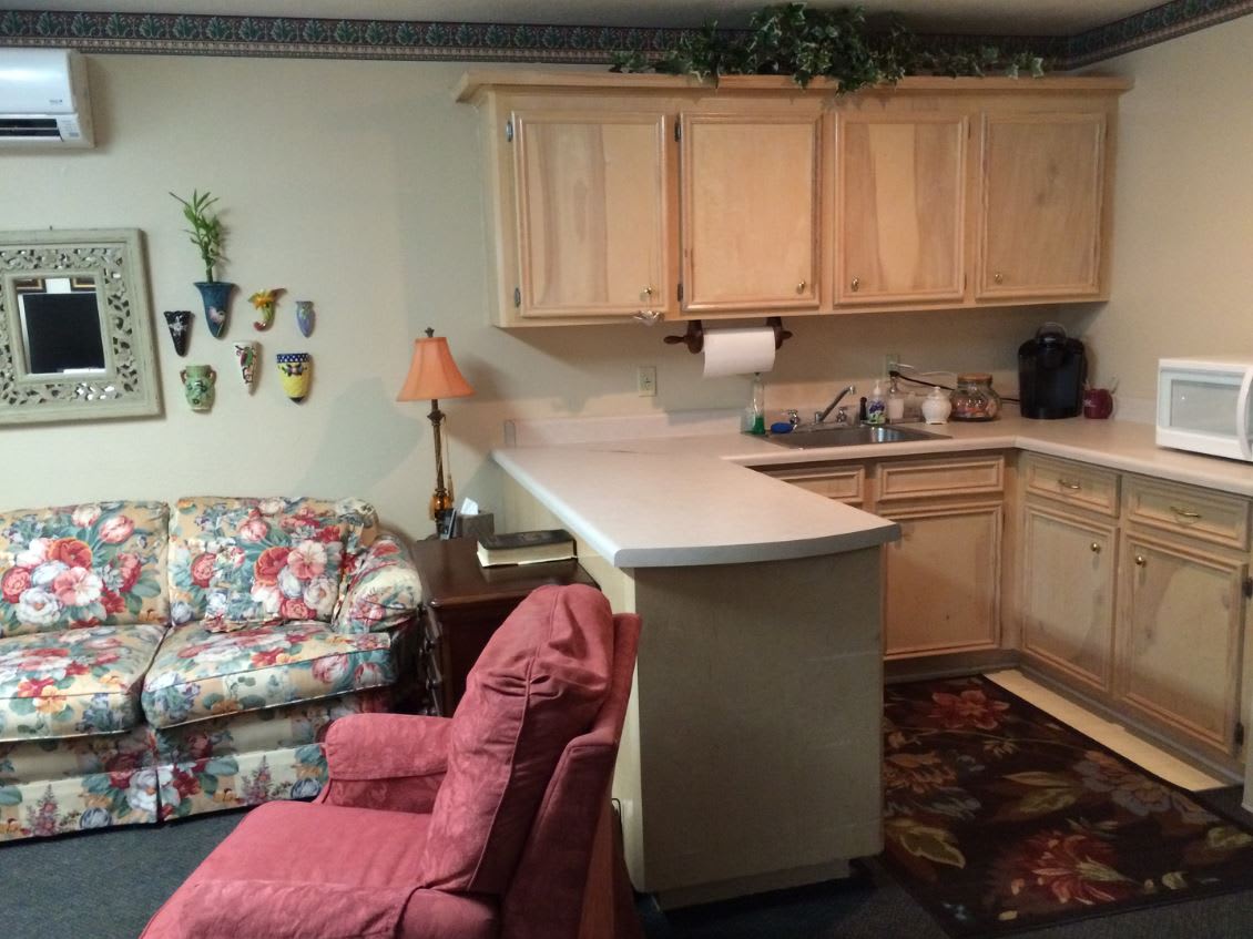Cozy kitchen area with seating and decorative elements.