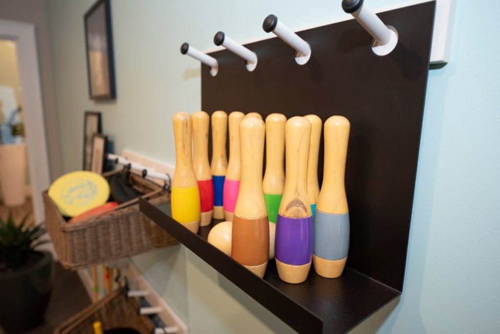 A set of colorful wooden toys neatly organized on a shelf.