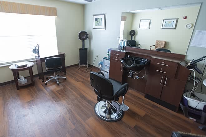 A well-organized barbershop interior with chairs and a large mirror.
