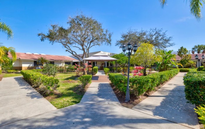 A charming house with a beautifully landscaped garden and pathways.