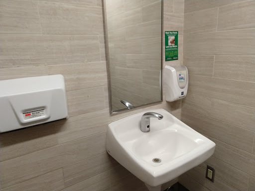 A clean and modern bathroom setup featuring a sink and mirror.