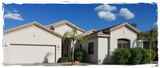 A beautiful residential house with a palm tree under a clear blue sky.