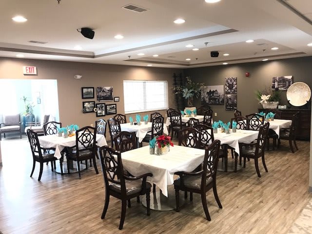 An elegant dining room setup with neatly arranged tables and chairs.