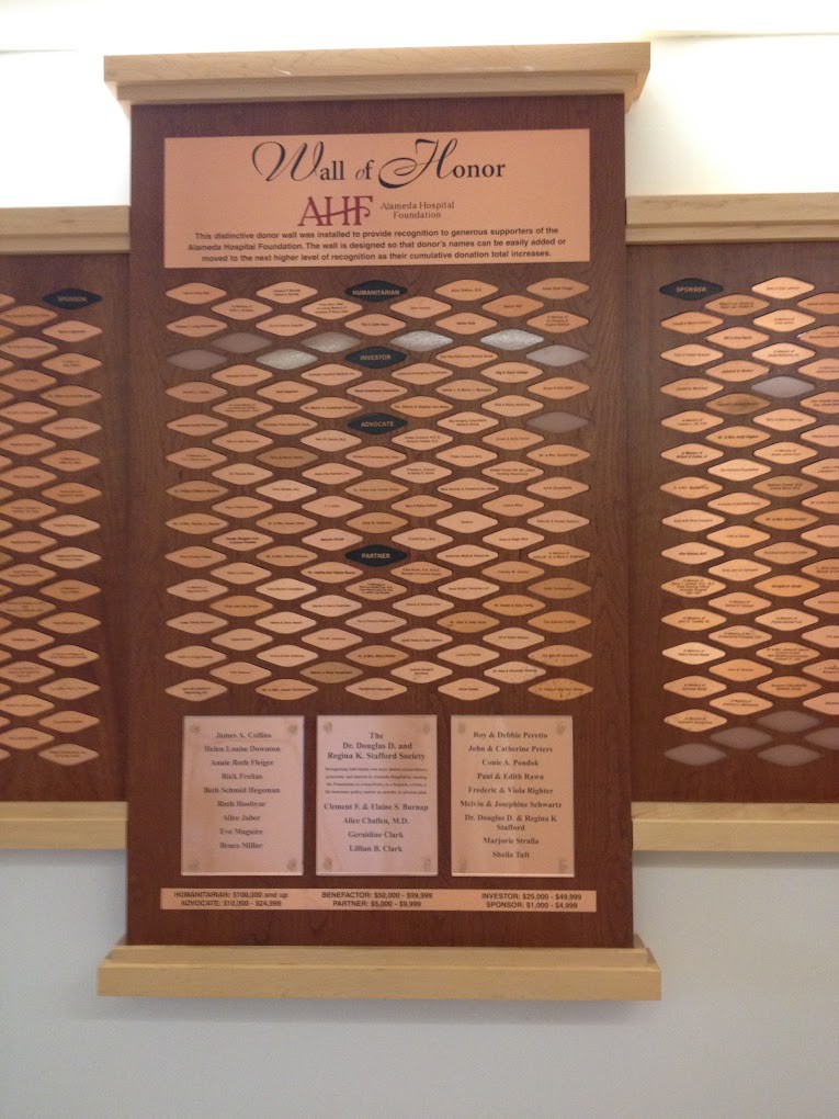 A donor recognition wall displaying engraved plaques honoring contributors.
