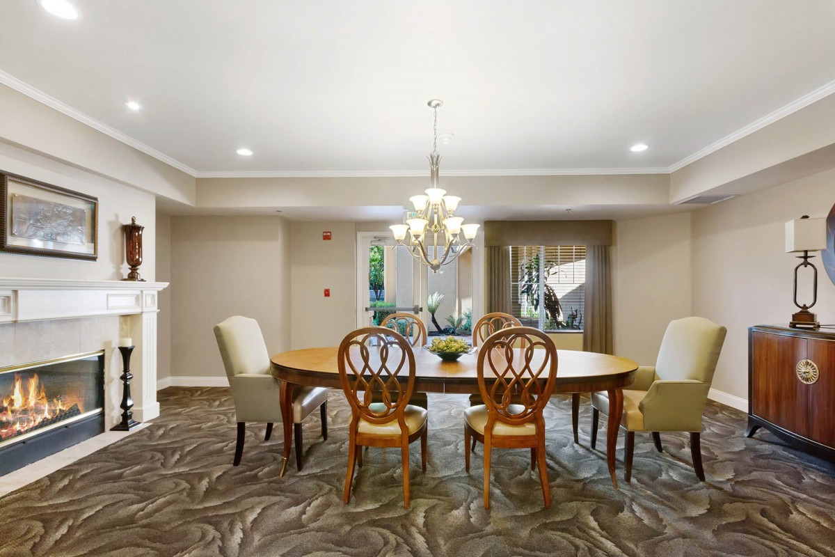 Elegant dining room with a chandelier and wooden dining table.